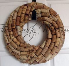 a wreath made out of wine corks hanging on a door