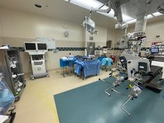 a hospital room filled with medical equipment and lots of blue cloths on the floor