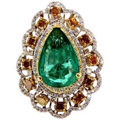 Green Pear Allure. 8.63ct. Natural GIA Certified Emerald Ring GIA Certified Report ID: 5161616364 18.78 X 12.46 X 5.71mm Full cut pear brilliant Clean Clarity & Transparent Vivid Green / Zambia Best GIA= "F2" 12 Natural Fancy color Diamonds. Ovals, Cushions & Pear all full cut brilliants Fancy Color yellow orange brown Vs-2 clarity. 2.00ct round, white diamonds G-color Vs-2 clarity. 18kt. white gold 19.2 grams Ring Current size: 7.5 Depth of ring: .53 inch Deck of ring: 1.44 X 1.08 inch (Free Resize Service, Please inquire) Video upon request. $60,000 Appraisal Certificate to accompany & GIA Pink Diamond Halo Ring, Emerald Diamond Ring, Diamond Cocktail Rings, Fancy Color Diamonds, Gems Jewelry, Zambia, Yellow Diamond, Natural Emerald, Emerald Diamond