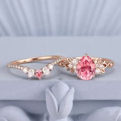 two rings with pink and white diamonds on them