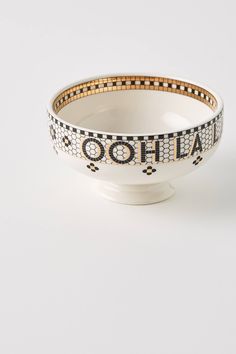 a white bowl with black and gold lettering on the side that says,'oohla '