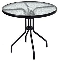 a round glass table with black metal legs and an iron base, against a white background