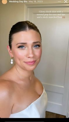 a woman in a white dress smiling at the camera