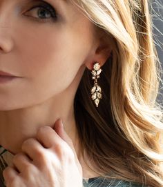 a close up of a person wearing some kind of earring with flowers on it