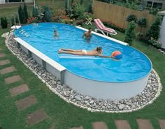 an above ground swimming pool with people playing in it