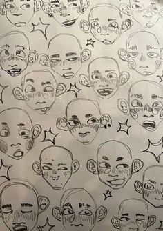 a bunch of different faces drawn on paper