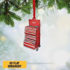 a red toolbox ornament hanging from a christmas tree