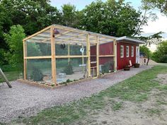 a small red house with a chicken coop in it