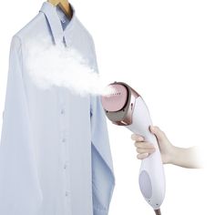 a person holding a blow dryer in front of a shirt