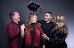 a group of people standing next to each other with a graduation cap on their head