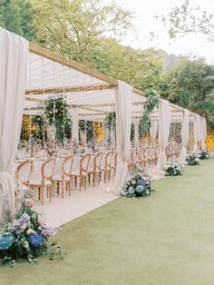 an outdoor wedding setup with chairs and flowers