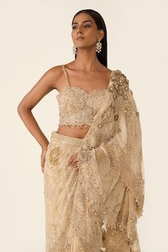 Golden pre-draped saree features dori work, dabka, cutdana, sequins, Swarovski and 3D flower embroidery and small crystals detailing on the edges. Comes with golden embroidered blouse with bead work. - Aza Fashions Golden Sari, Saree Gowns, Dhoti Saree, Cotton Sarees Handloom, Dori Work, Small Crystals, Ruffle Saree, Drape Saree, Lehenga Saree