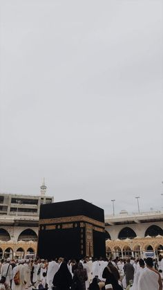 many people are gathered around the ka'bah in front of a large building