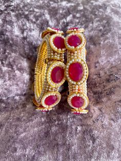 Absolutely stunning piece of meena bangle .Available in ruby and emerald green size 2/2 and 2/4, 2 of each size. You will receive one bangle. If you would like to buy two bangles contact me for combine shipping please if you have any queries please ask Traditional Ruby Bracelets For Festive Occasions, Traditional Ruby Bracelet For Festive Occasions, Round Meenakari Bangle As Gift, Pink Hand Set Bangle As A Gift, Red Stone Work Bracelets As A Gift, Temple Jewelry Style Round Bangle For Party, Red Meenakari Bracelets For Celebration, Temple Jewelry Style Bangle For Party, Temple Jewelry Bangle For Party