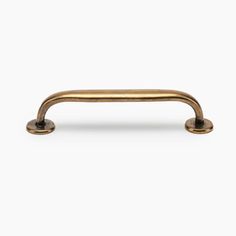 an antique brass pull handle on a white background