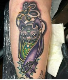 a cat tattoo on the leg of a person