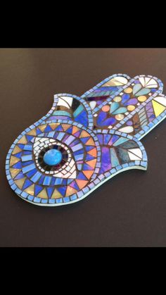 a stained glass brooch with an eye on it