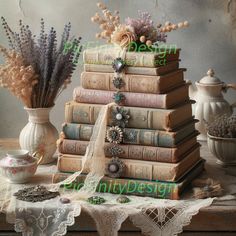 a stack of books sitting on top of a table next to vases filled with flowers