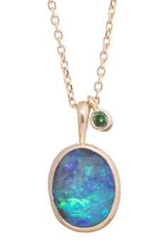 A vibrant Australian boulder opal that displays an overall striking indigo hue with bold flashes of electric green, aqua and periwinkle across its surface. This gorgeous combination of cool tones is complimented by a 2 mm faceted tsavorite gemstone that is suspended alongside. Framed in 10k gold, with a sterling back, this gorgeous 1.5 carat gem measures 9.7 x 8 mm. Suspended from an 18 inch diamond cut cable chain this stunning piece will add a magical element to your necklace collection. Please email kate@katedavisjewelry.com if you would like to view additional images or video. Luxury Round Stone Gemstone Necklace, Luxury Round Pendant Gemstone Beads Jewelry, Luxury Opal Necklaces With Gemstone Accents, Luxury Round Stone Gemstone Necklaces, Luxury Opal Necklace With Natural Stones, Kate Davis, Electric Green, Green Aqua, Necklace Collection