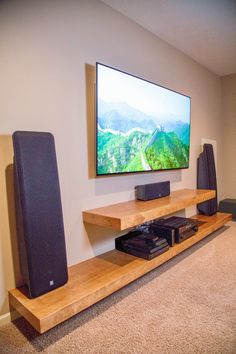 a flat screen tv mounted to the side of a wooden shelf in a living room