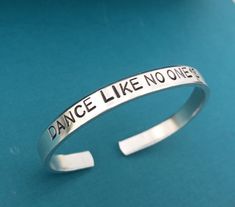 Dance Like No Ones Watching Hand Stamped Bracelet Cuff, Inspirational Gift Font shown is Arial This bracelet is ¼ inch wide and is made of a lightweight but thick and sturdy 12 gauge aluminum. Aluminum will NOT tarnish or rust! Read further down for more information on aluminum. Cheerleader Gift, Dance Team Gifts, Ballet Gift, Handstamped Bracelet, Cheerleading Gifts, Cheerleader Girl, Cheer Gifts, Dance Gifts, Stamped Bracelet