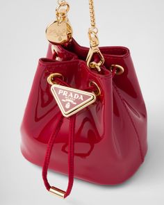 Drawstring closure Enameled metal triangle logo on closure Removable chain shoulder strap Leather interior Triangle Logo, Bags Designer Fashion, Leather Pouch, Leather Chain, Cherry Red, Leather Mini