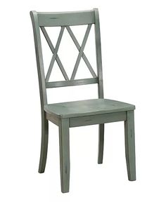 a wooden chair with a cross back and green paint on the seat, against a white background