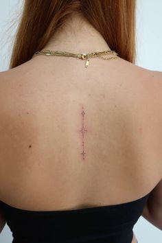 a woman with a cross tattoo on her back