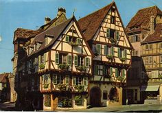 an old building with many windows and flowers on it