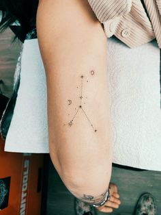 a woman's arm with a small star tattoo on it