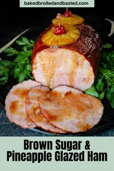 brown sugar and pineapple glazed ham on a black plate with text that reads brown sugar and pineapple glazed ham