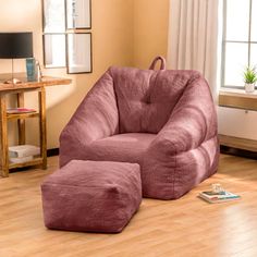 a pink bean bag chair and ottoman in a living room