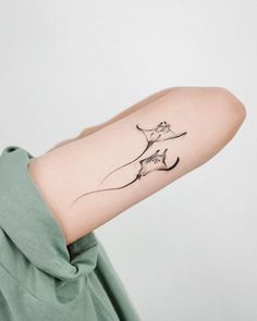 a woman's arm with a tattoo on it that has a cat flying through the air