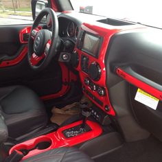 the interior of a red and black sports car