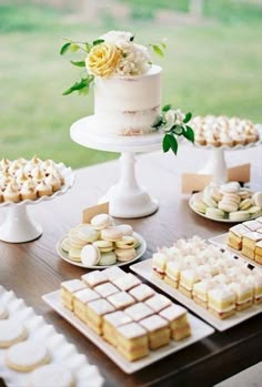 a table topped with lots of cakes and desserts