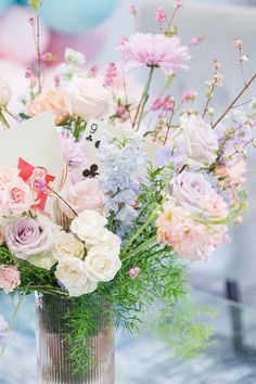 a vase filled with lots of flowers on top of a table