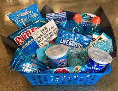 a blue basket filled with snacks and drinks