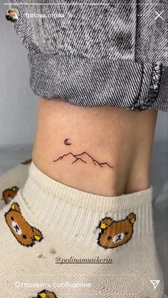 a small bear tattoo on the side of a woman's lower back ribcage