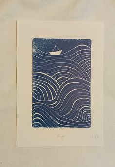 a blue and white print with a boat floating in the ocean on it's side