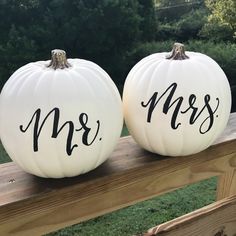 two white pumpkins with mr and mrs painted on them