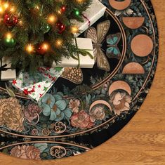 a christmas tree with presents under it on top of a round table covered in ornaments