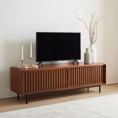 a flat screen tv sitting on top of a wooden cabinet