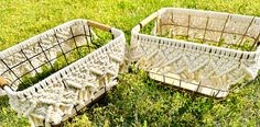 two baskets sitting on top of a lush green field next to each other in the grass