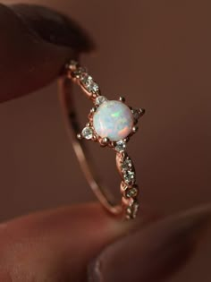 A subtly sparkling cubic zirconia encrusted rose gold band complements a single opal stone in this stunning Opal Diamante Ring. The multidimensional, iridescent shift of the lab simulated opal will stand out of the crowd while seamlessly pairing with all of your other rings and any day or night look. ........................... RING SIZE & MATERIAL❋ lab simulated opal❋ high quality cubic zirconia❋ 18k rose gold plated solid sterling silver❋ nickel free Unique Crystal Rings, Promise Ring Crystal, Spiritual Engagement Rings, Opal And Gold Ring, Gemstone Promise Ring, Promise Ring Opal, Silver Crystal Rings Engagement, Opal Rings Silver, Wedding Rings With Crystals