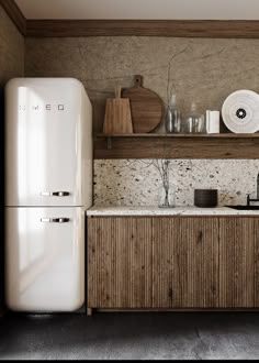 a white refrigerator freezer sitting next to a wooden shelf filled with plates and bowls