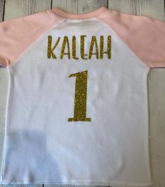 Personalized 2 year old girl Birthday Shirt, Girls 2nd Birthday Shirt, 2nd Birthday Outfit, Pink Second Birthday Outfit, Two Shirt for Girl Your little lady will look beyond adorable in this pink Ragaln Birthday Shirt with her age displayed proudly across the front of her shirt! You can also add your little ones name and age on the back of this shirt. To do so make sure to select the option from the drop down box that says Shirt/name&age. If the option Shirt Only is selected, no name or age Pink Crew Neck Top For Birthday, Pink Number Print T-shirt For Birthday, Pink Crew Neck Top For First Birthday, Pink Short Sleeve T-shirt With Number Print, Cute Number Print Tops For Birthday, Cute Tops With Number Print For Birthday, Pink Long Sleeve Top For Birthday, Personalized Pink Top For First Birthday, Personalized Pink Tops For First Birthday