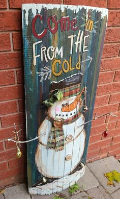 a wooden sign that says come in from the cold with a snowman on it