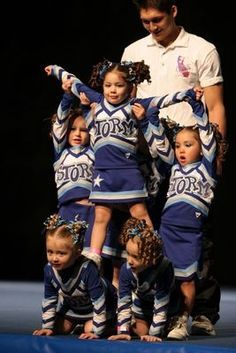 a group of cheerleaders standing on top of each other