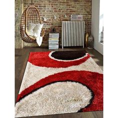 a red and black area rug in front of a brick wall with a radiator