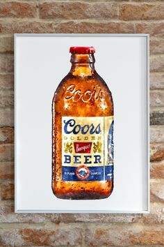 a beer bottle with the word coors on it in front of a brick wall